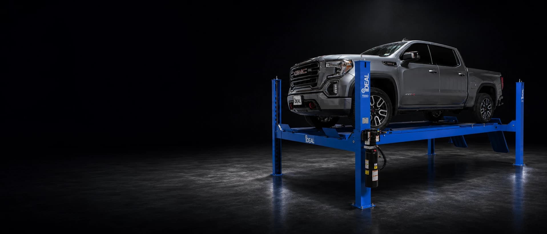 Pickup truck positioned on a professional four-post automotive lift