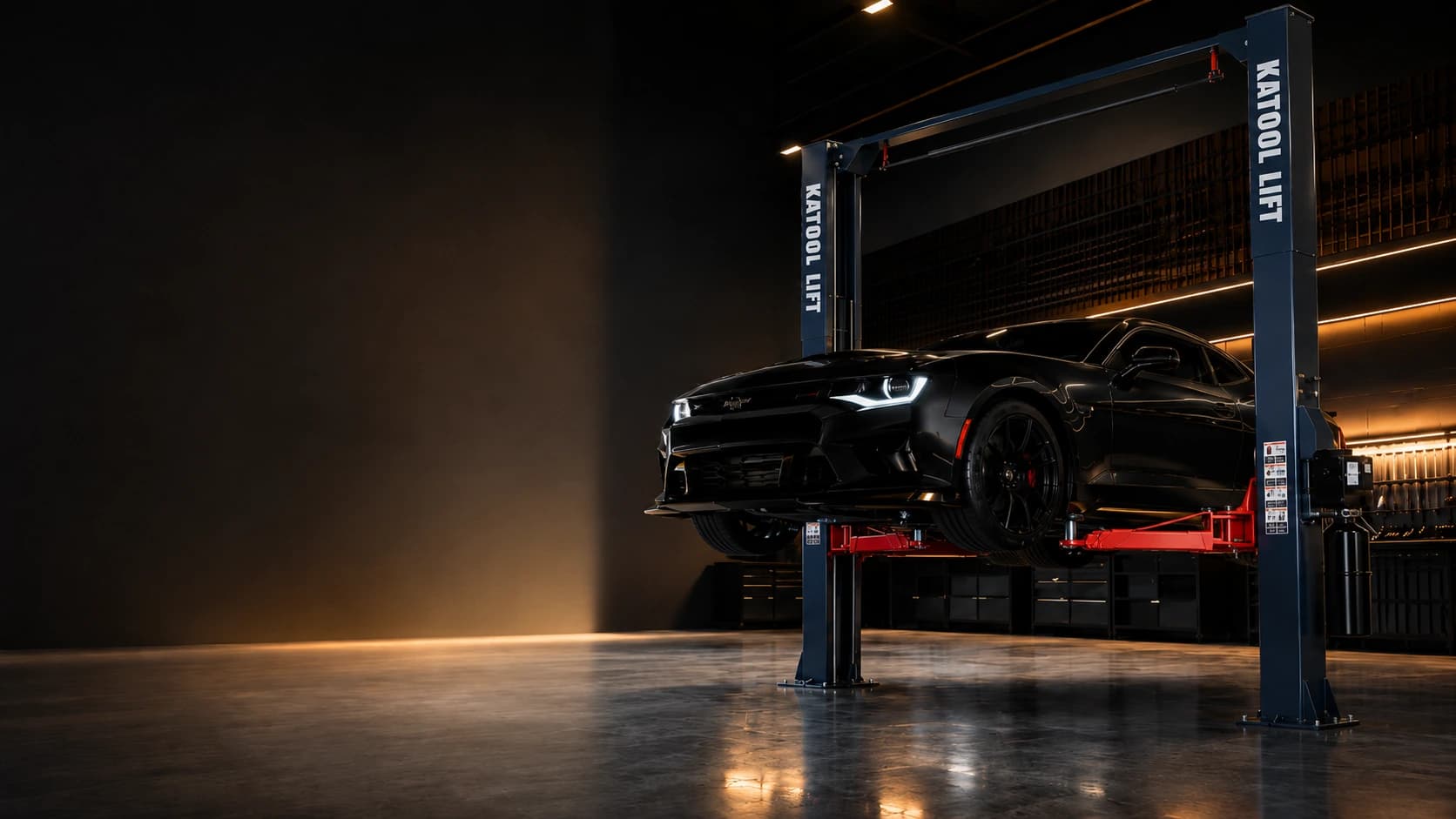Black sports car raised on a KATOOL two-post automotive lift